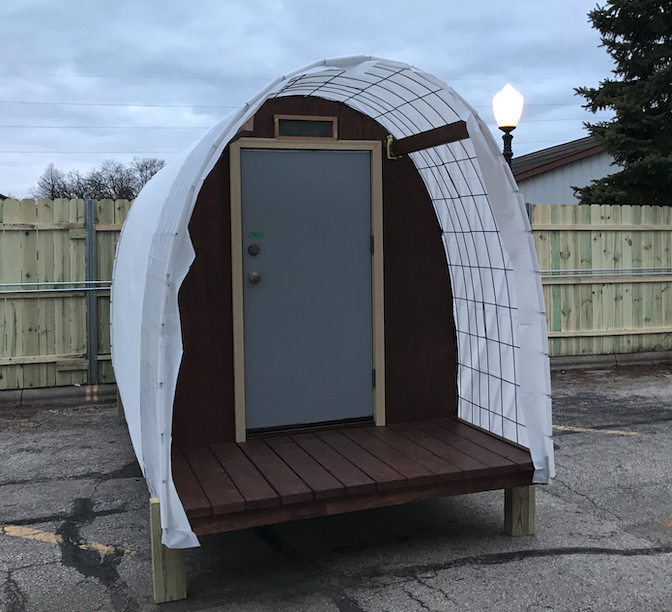 How can I support the new tiny house village?